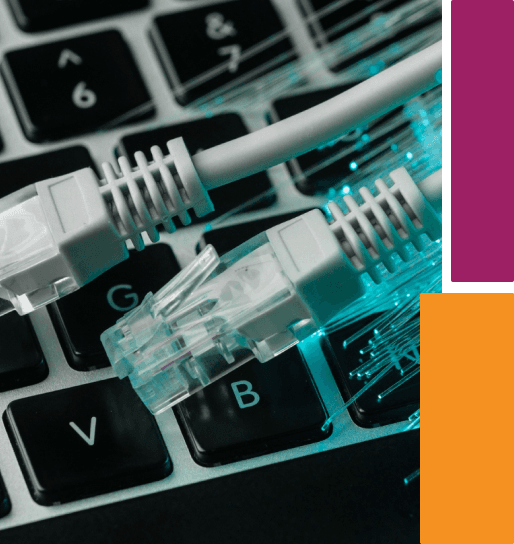 Network ethernet cables plugged into a keyboard with teal lighting