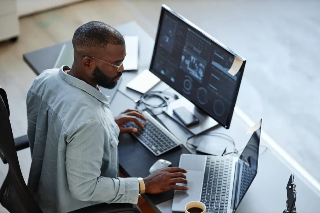 DataposIT engineer working at a multi-screen workstation